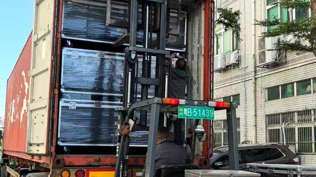 Flight cases loaded into a shipping container